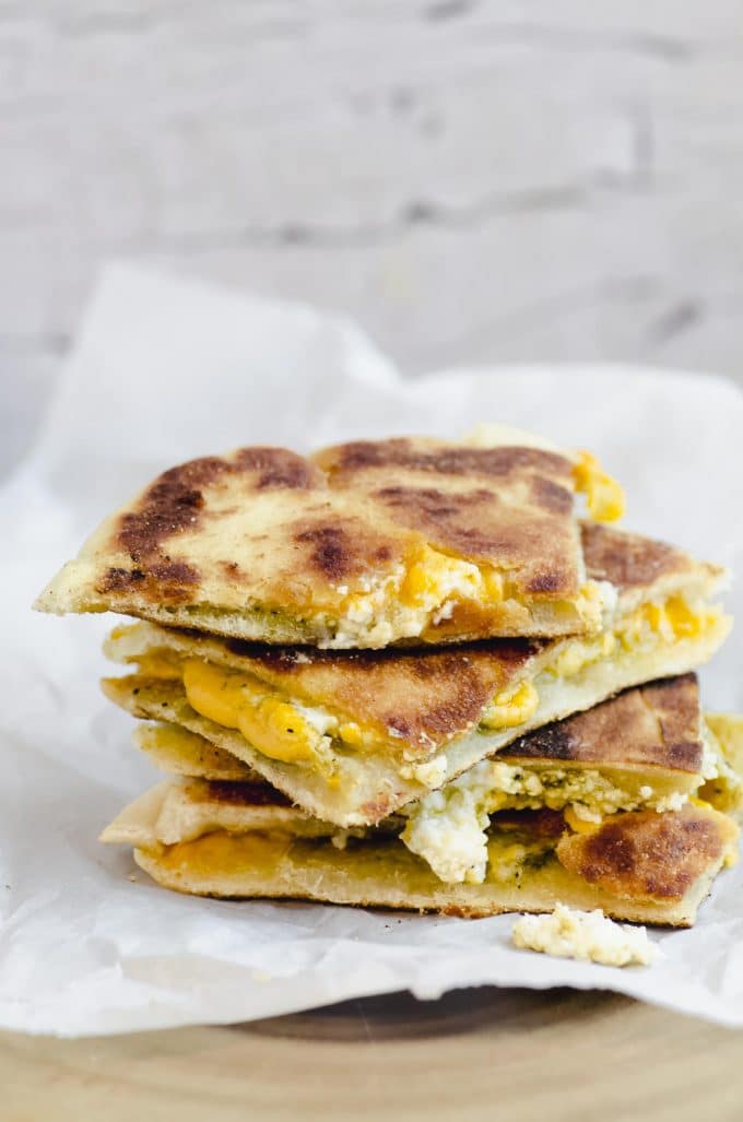 Side view of a grilled cheese pita sandwich cut in quarters and stacked