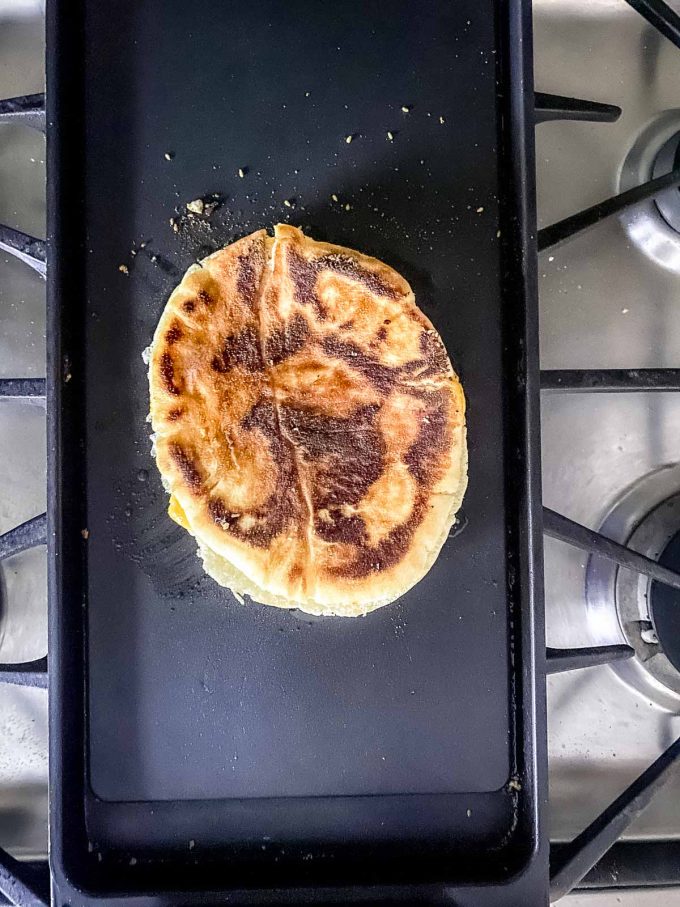 A grilled cheese pita sandwich on  griddle