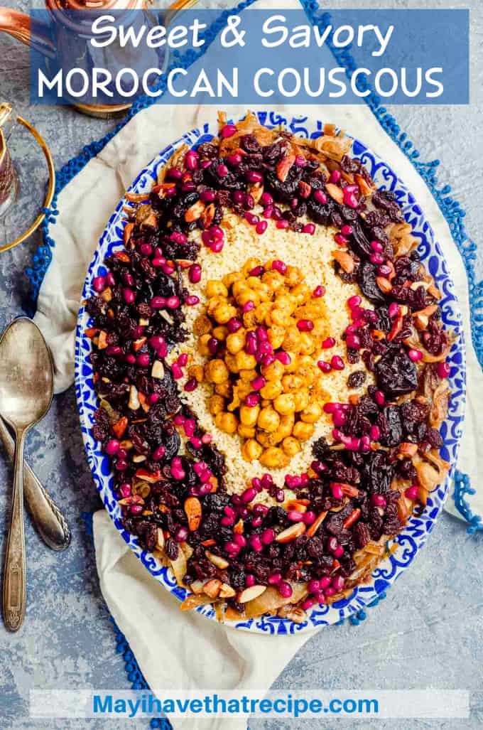 overhead view of an oval serving dish with moroccan couscous with prunes, raisins, almonds and pomegranate seeds