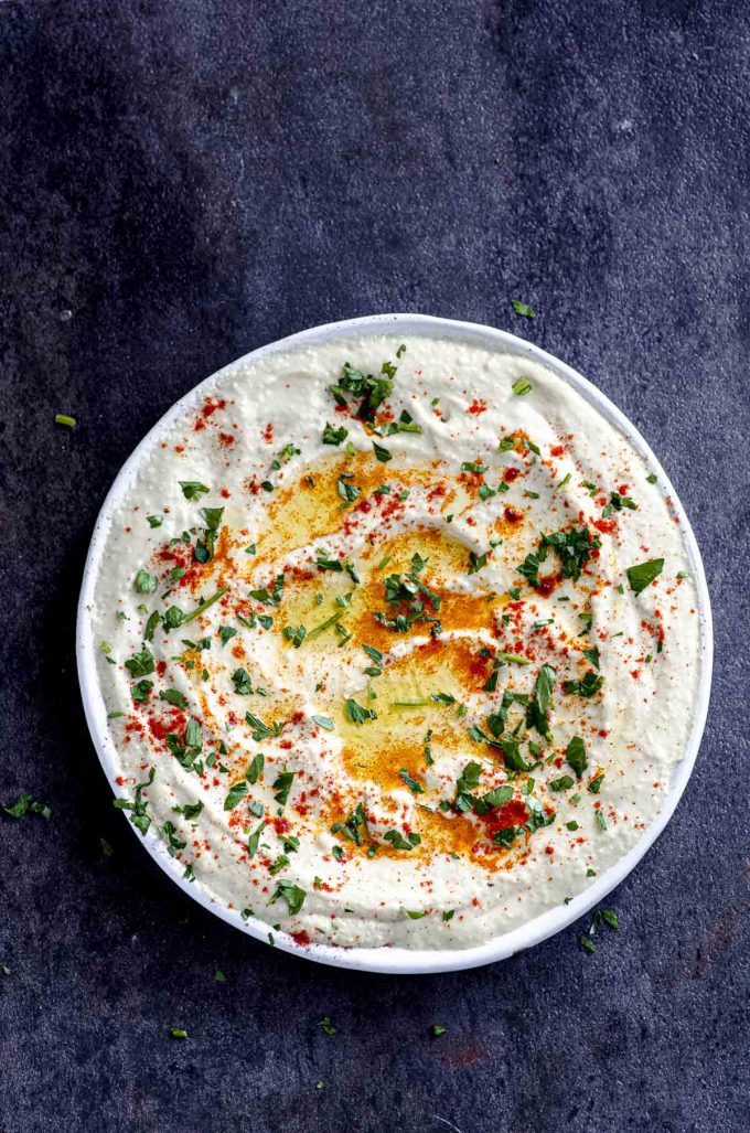 Hummus plate with olive oil, paprika and chopped parsley