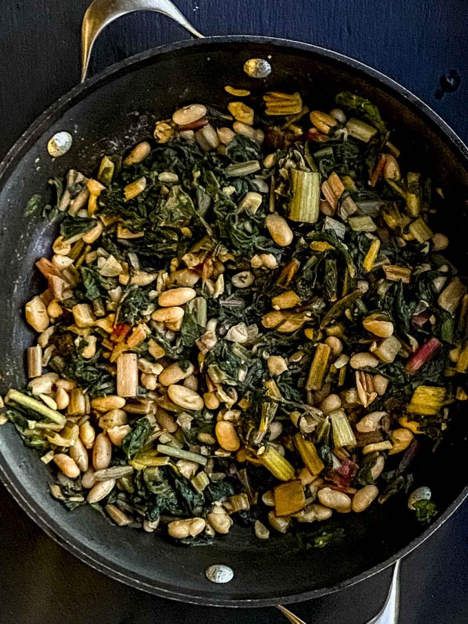 Chard and cannellini beans on a large skillet