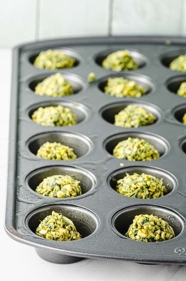 Side view of a mini muffin tin with falafel balls
