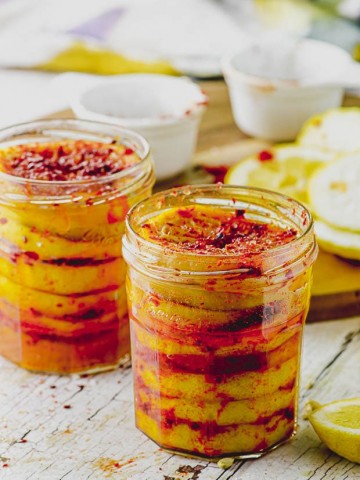 Close up of two jars filled with preserved lemons