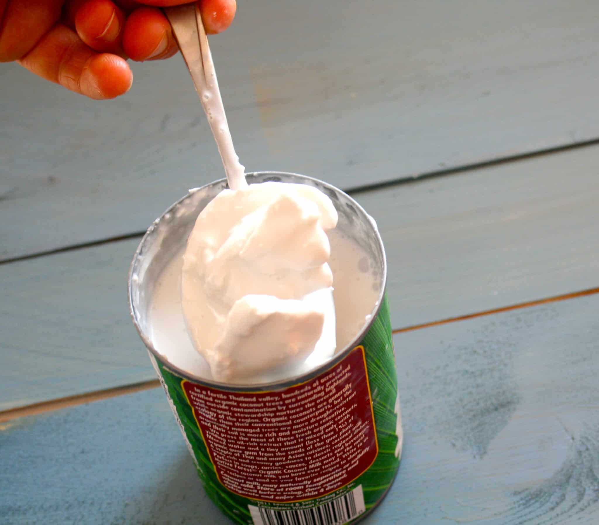scooping coconut cream from a can