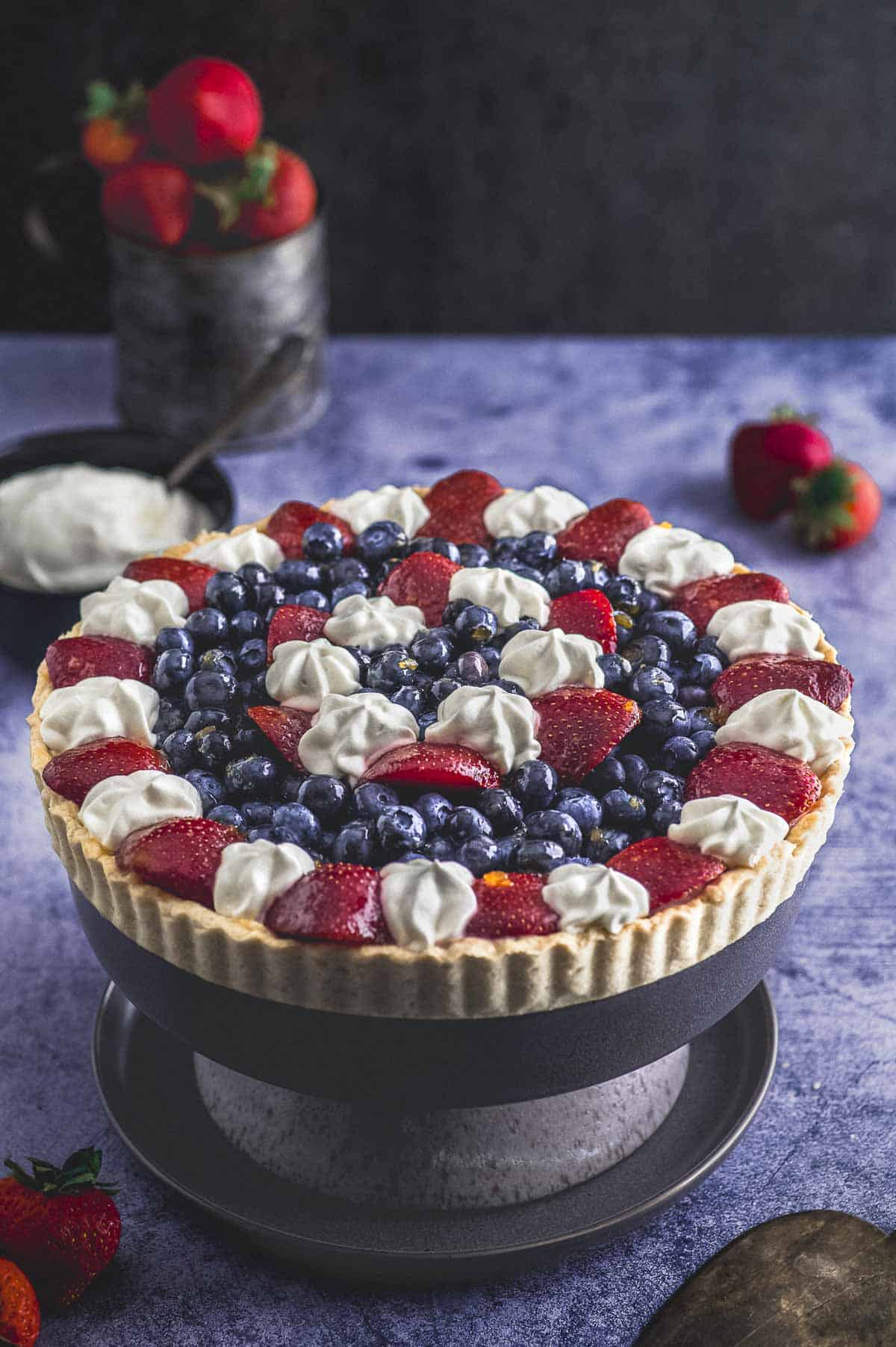 close up view of a vegan fruit tart with blueberries and strawberries
