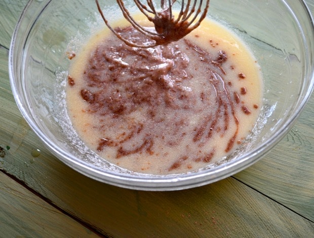 Glass bowl with non dairy yogurt, oil and flax eggs with a whisk