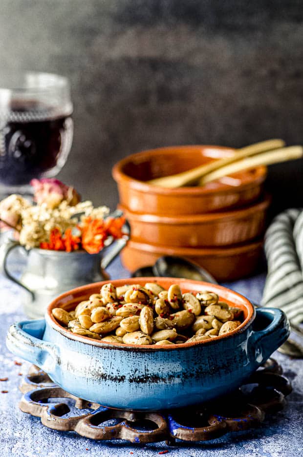 Side view of a blue ceramic bowl filled with cooked cranberry beans