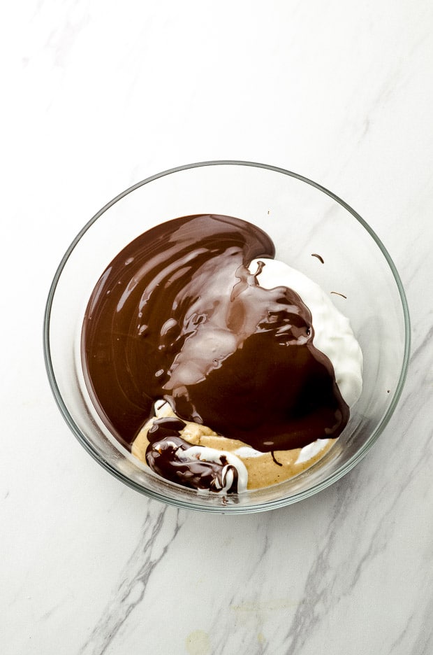 Bird's eye view of melted chocolate, yogurt and peanut butter in a glass bowl