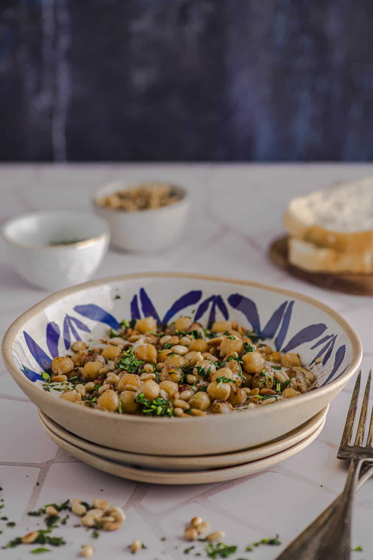 Side view of a plate of musabaha (deconstructed hummus)