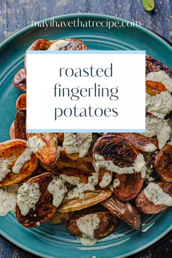 A closer view of a bowl of roasted fingerling potatoes with horseradish sauce drizzled on top