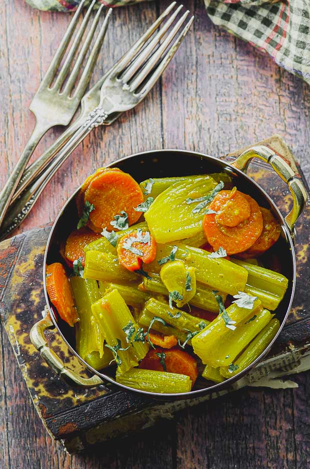 Bird's eye view of a small pan with warm braised celery salad