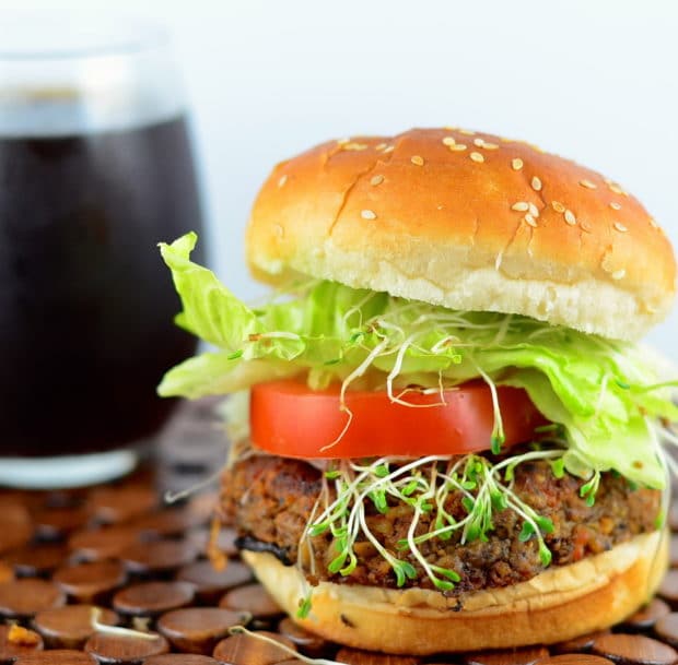 A close up of a tempeh black bean burger, part of our best veggie burgers roundup.