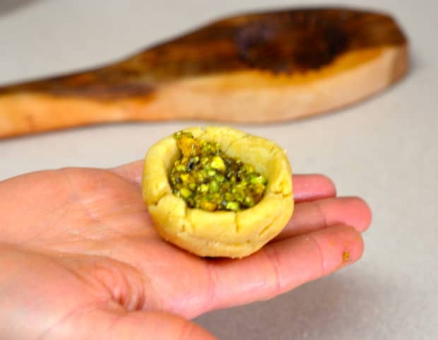 Raw maamoul dough filled with pistachios