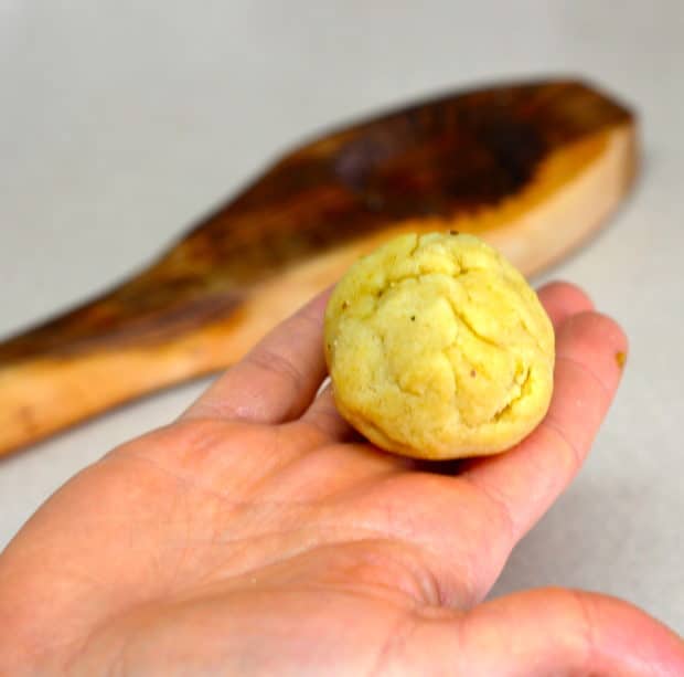 Shaping the pistachio filled dough into a ball