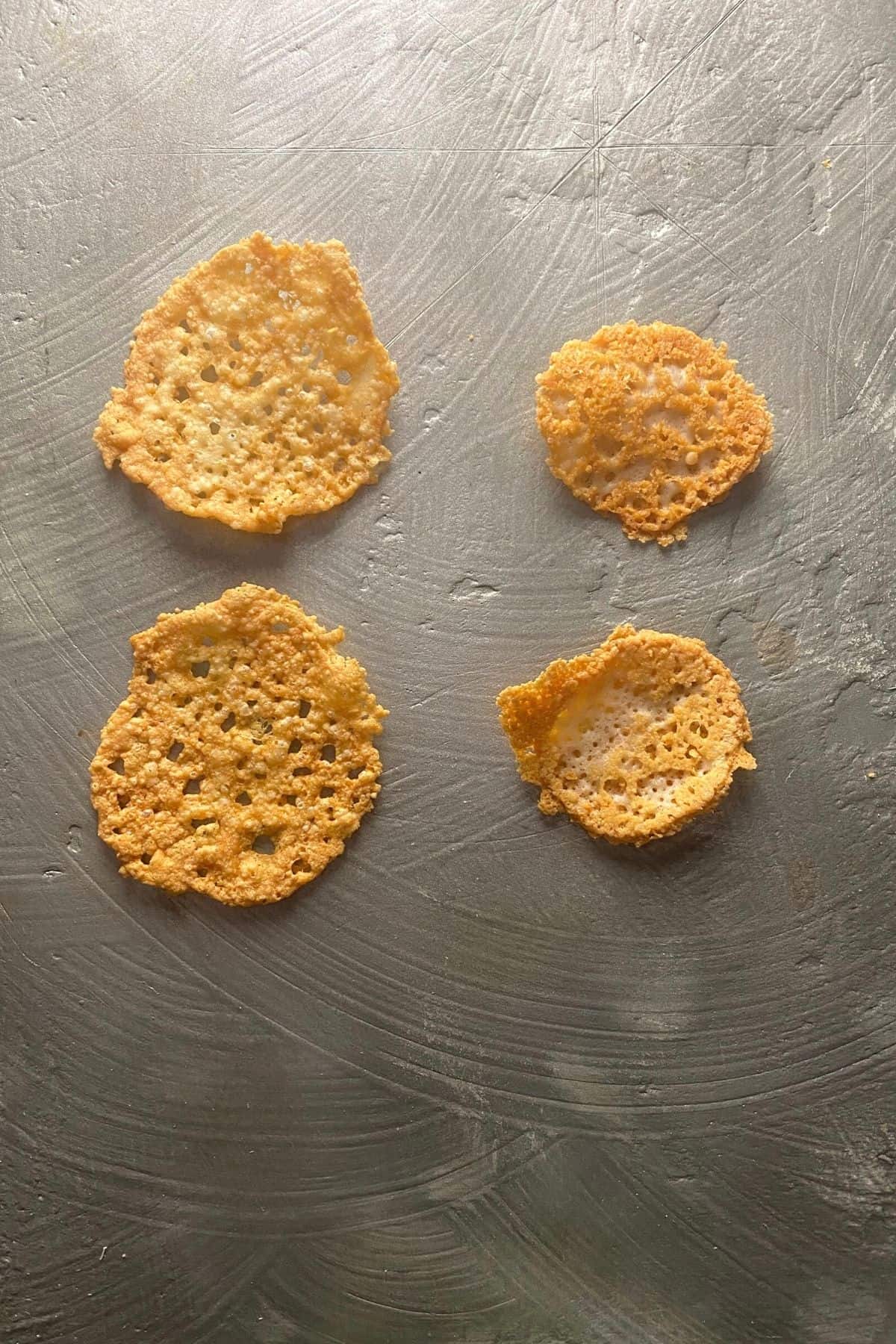 A comparison of the size of parmesan crisps made in the oven vs. pan fried