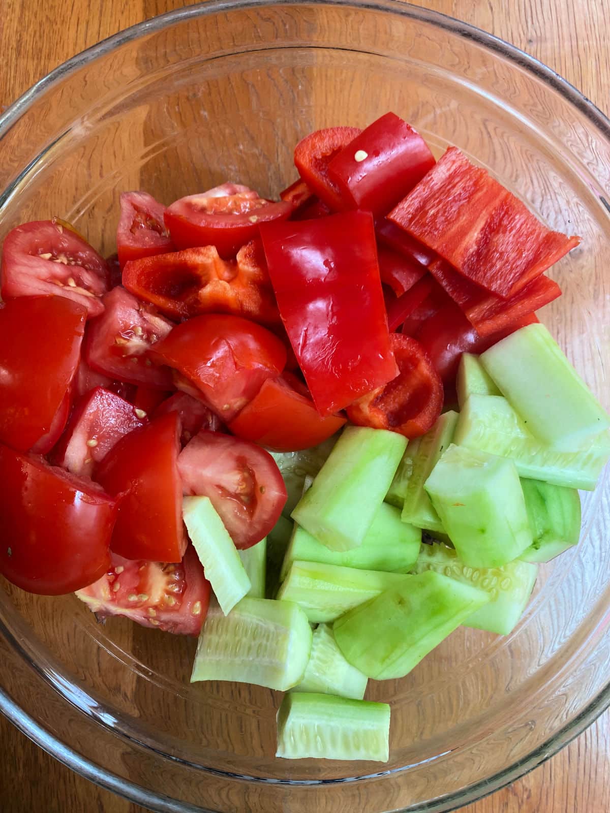 tomatoes, cucumbers and peppers in a bowl