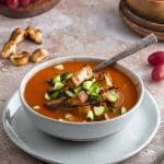 Close up of A bowl of gazpacho with a spoon inside the bowl