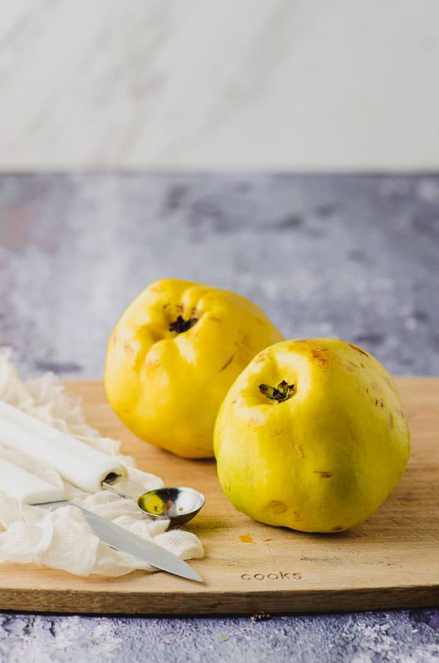 Two quince on a wood board