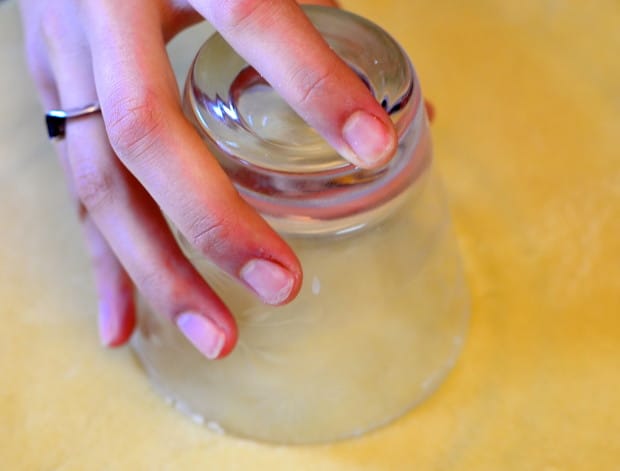making a circle in the boureka dough with a round glass