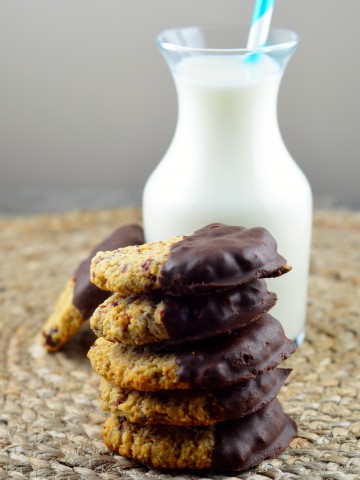 Stacked cranberry coconut cookies with a small bottle of milk