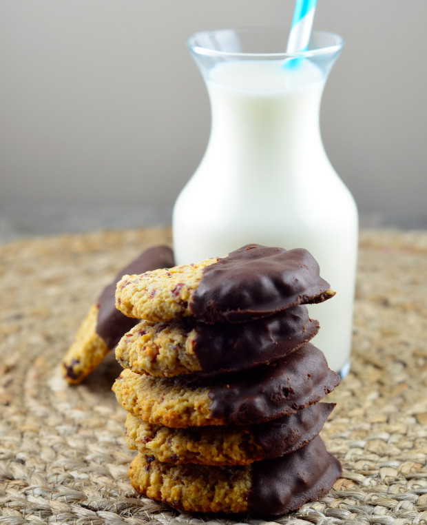 Stacked cranberry coconut cookies with a small bottle of milk