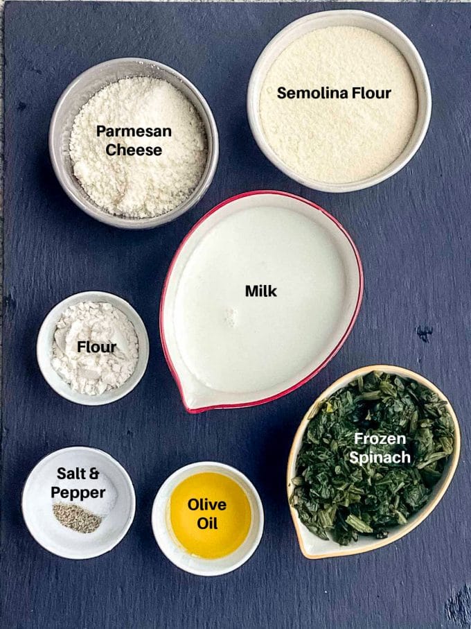 Ingredients to make semolina gnocchi labeled. semolina flour, milk, parmesan cheese flour, oil, spinach, salt and pepper