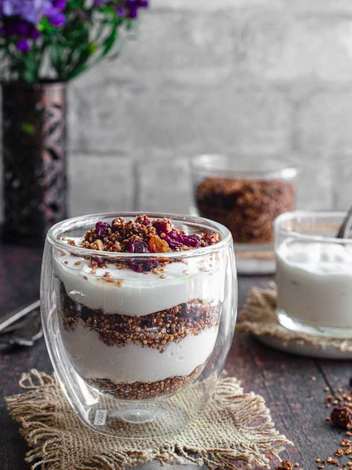 A closer view of a cup of quinoa granola layered with yogurt