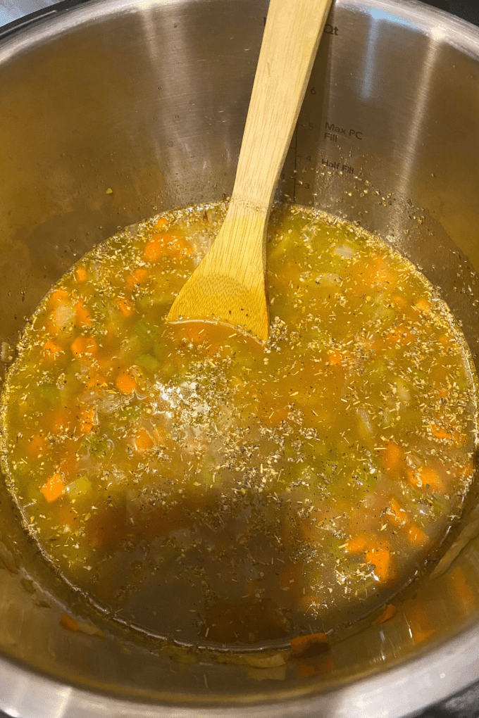 An overhead view of the ingredients to make split pea soup all mixed together in a pot ready to be cooked