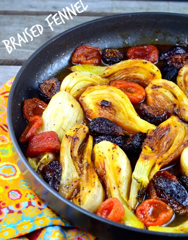Close up of Braised Fennel with Apricots & Figs in a skillet over a yellow cloth napkin