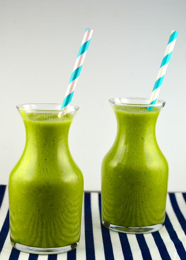 Side view of two bottles filled with tropical green smoothie
