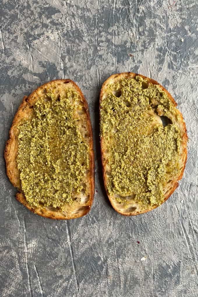Two slices of toasted sourdough with pesto