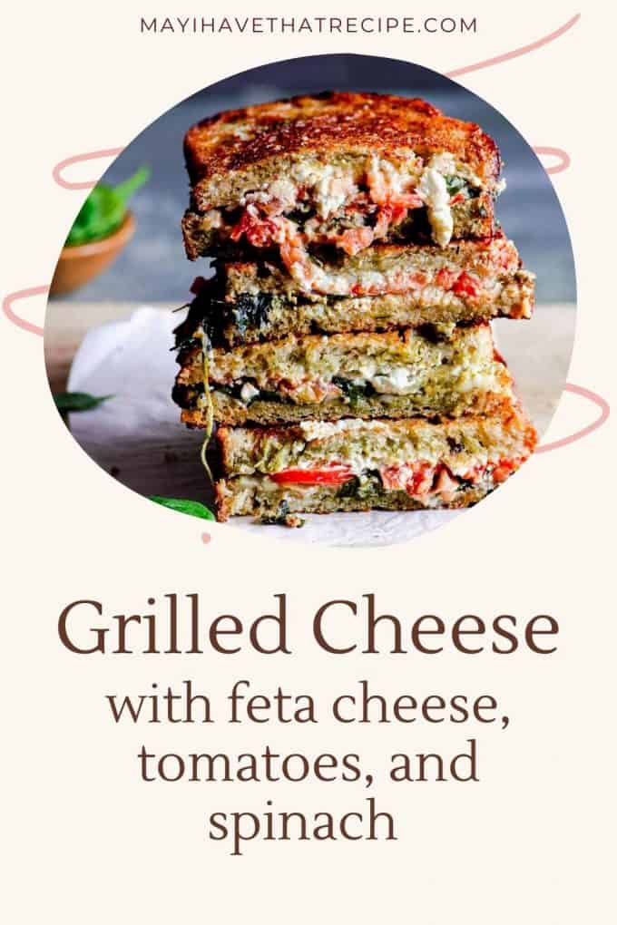 Grilled cheese with feta cheese, tomatoes, and spinach cut into squares stacked up like a tower