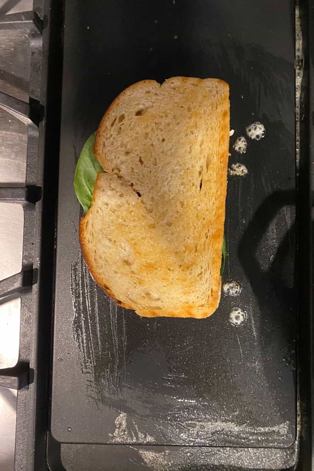 A best grilled cheese sandwich being grilled on a griddle