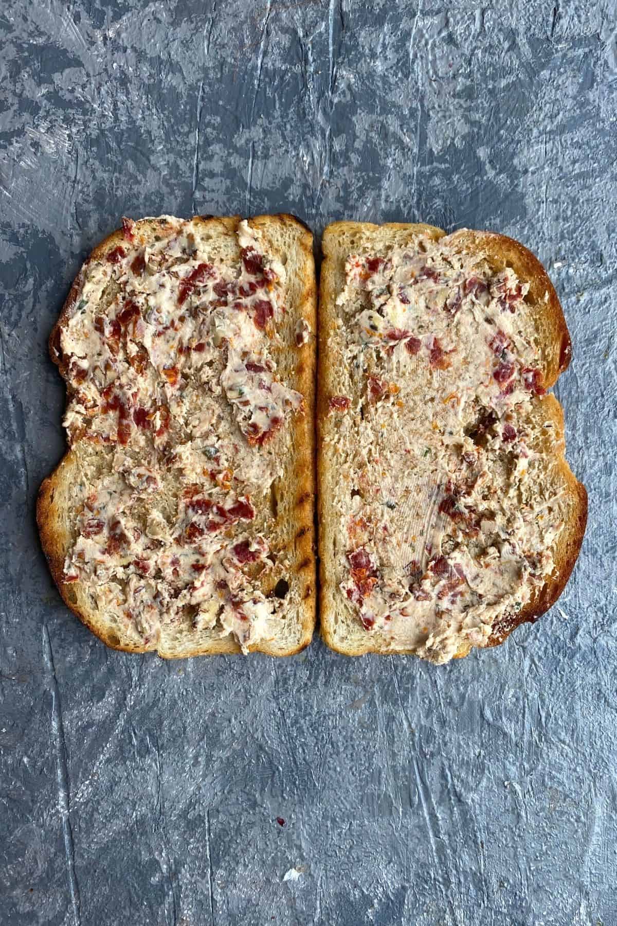 Two pieces of bread open faced sourdough with cheese walnut mixture