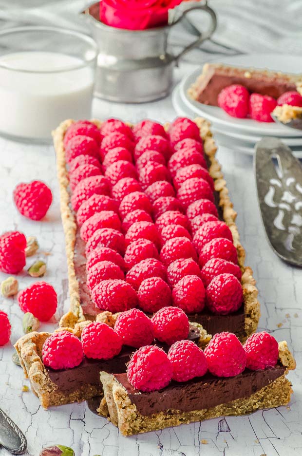 Side view of a stunning vegan raspberry chocolate tart