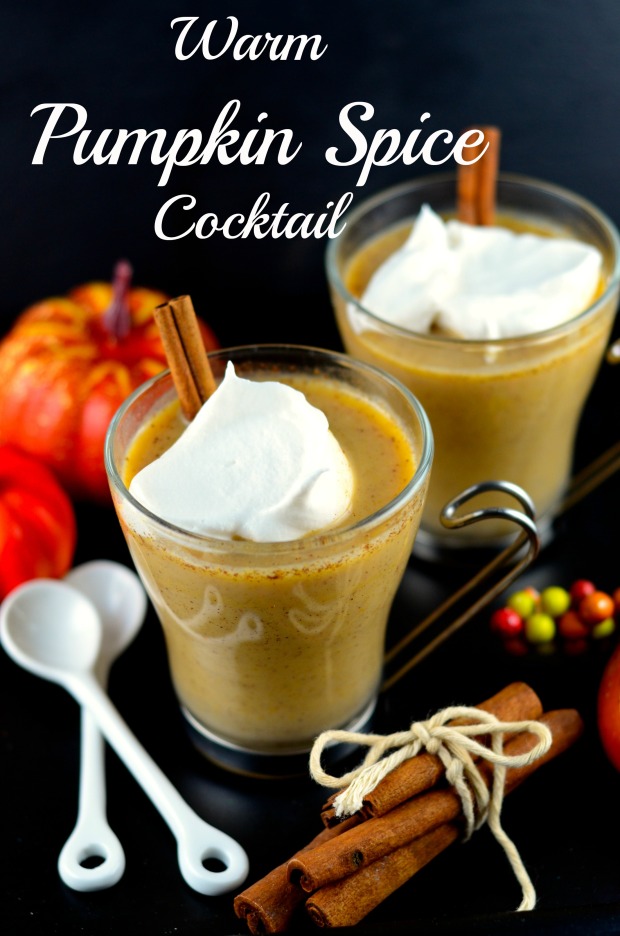 Two warm pumpkin spice cocktails in clear glasses.