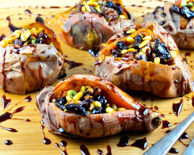  Stuffed Baby Sweet Potatoes With Maple Pomegranate Drizzle - We have updated the mighty sweet potato in to a fancy, but easy to make vegetarian, vegan and gluten free appetizer or side dish. A simple few ingredient recipe that will keep you full and satisfied. The Pine nuts, pistachios, prunes and raisins contrast perfectly with the tangy pomegranate drizzle. Perfect for your next Super Bowl Party, Passover dinner, or holiday get together. The best part you can use the left overs for lunch!