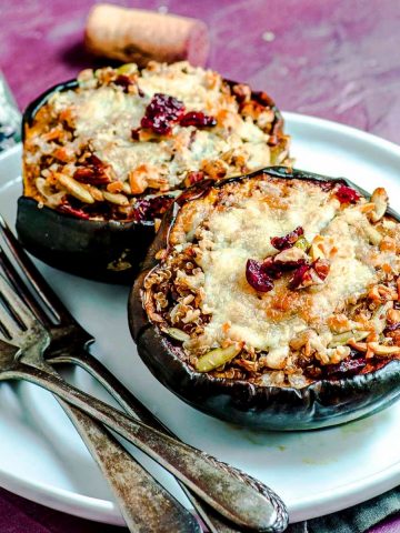 An angled view of two halves of vegetarian stuffed acorn squash
