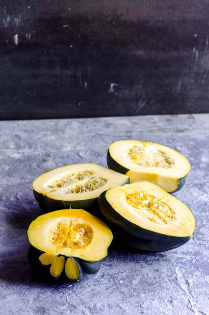An angled view of acorn squash sliced in half