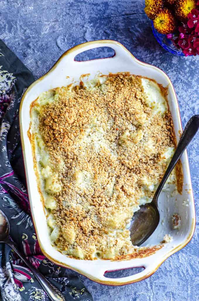 An overhead view of cauliflower gratin in a baking dish with a spoonful taken out