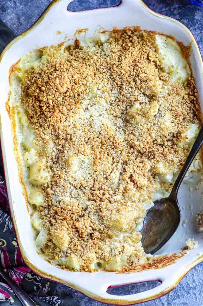 An overhead view of cauliflower gratin in a baking dish with a spoonful taken out
