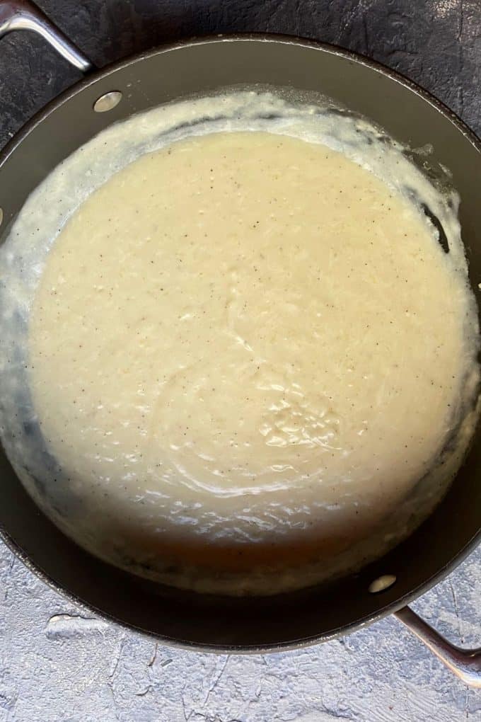 An overhead view of bechamel sauce in a skillet