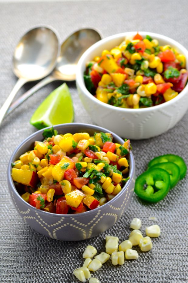 Two small bowls filled with nectarine corn salsa with jalapeños and cilantro.