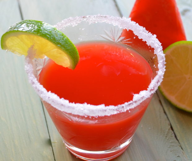 Side view of a glass of Watermelon Limeade with salt on the rim