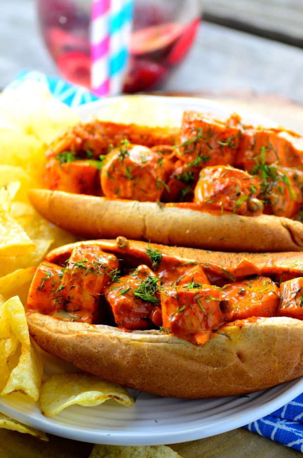 Closeup view of two rolled filled with vegan lobster in a red spicy sauce