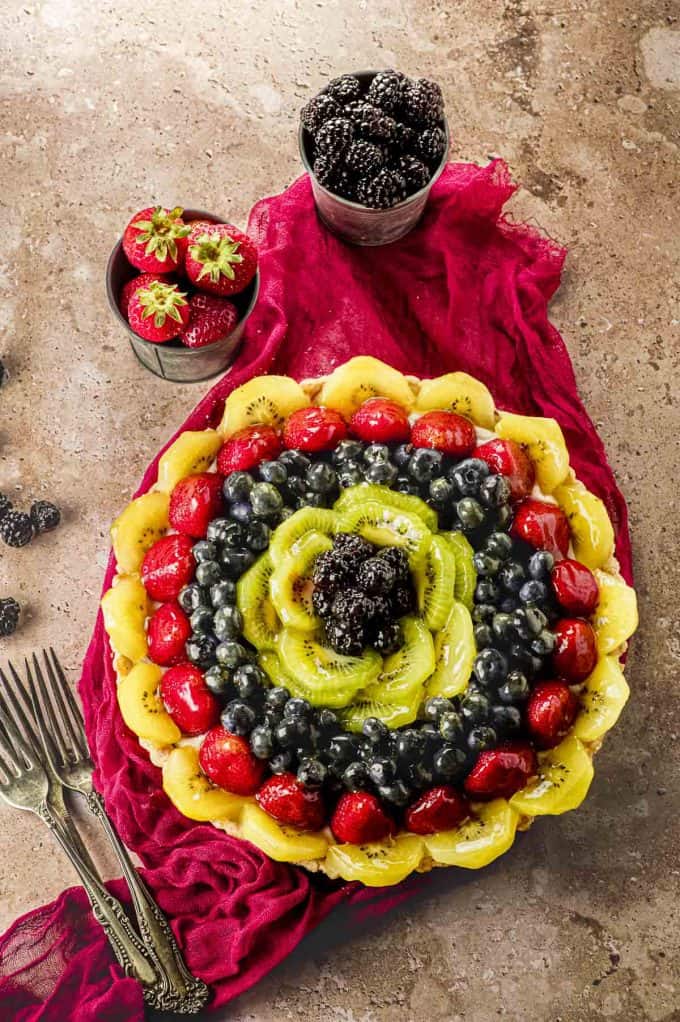 overhead view of a fruit tart on a stone background