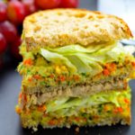 Side view of a smashed chickpea salad sandwich