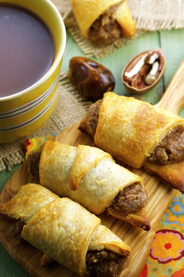 Close up view  Bourbon Pecan Cream Crescent Rolls  next to a cup of coffee

