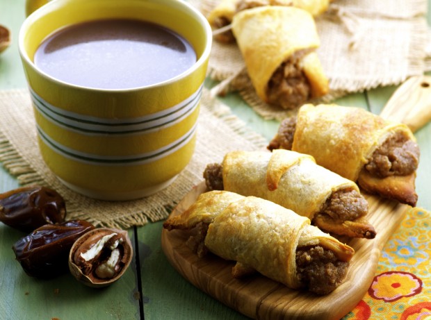 Bourbon Pecan Cream Crescent Rolls next to a cup of coffee
