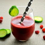 Side view of a glass with a red detox smoothie